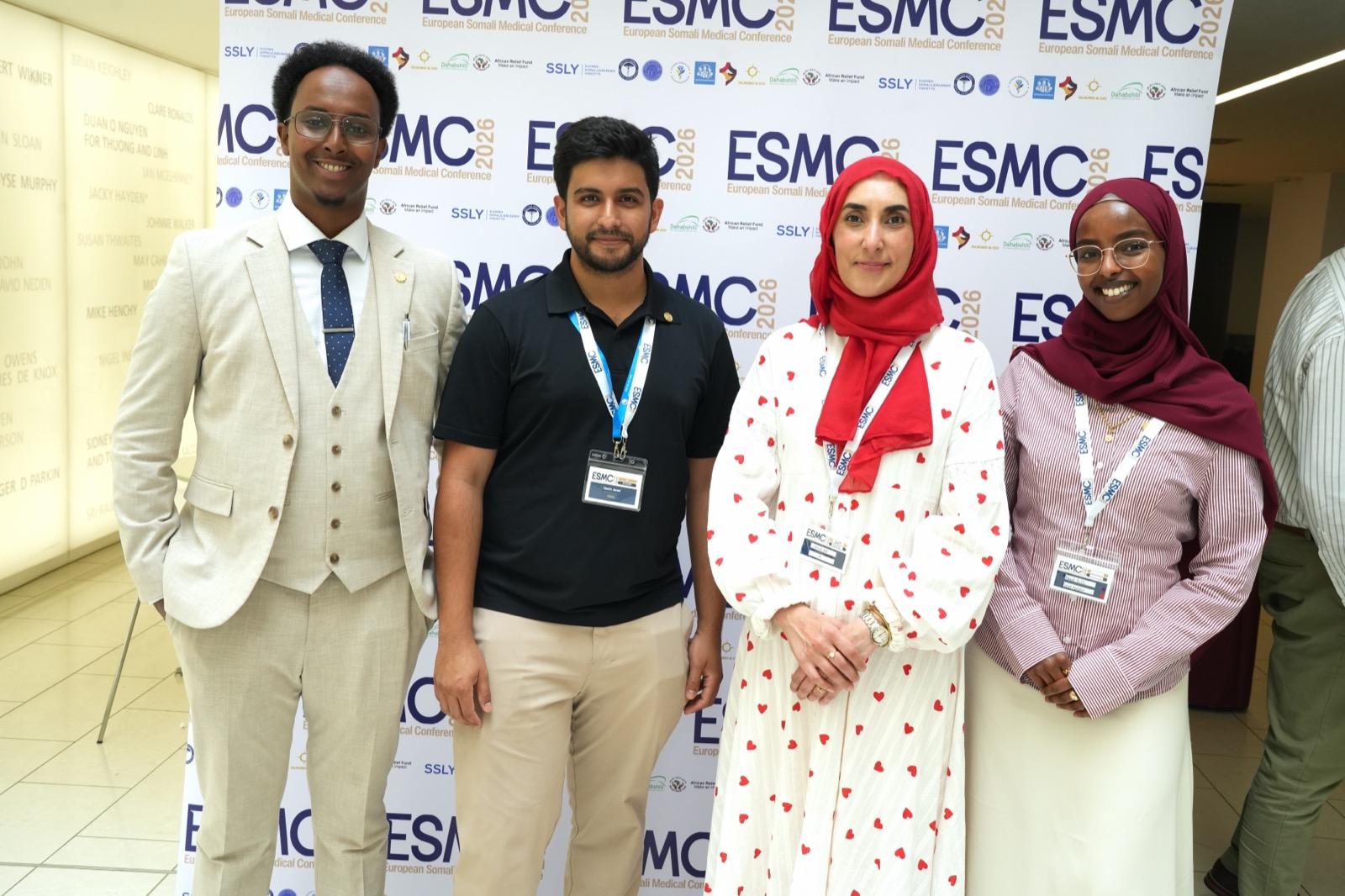 Four young delegates in front of the conference banner at the European Somali Medical Conference 2026